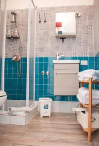ナポリにあるB&B Epoche'の青いタイル張りのバスルーム(シャワー付)
