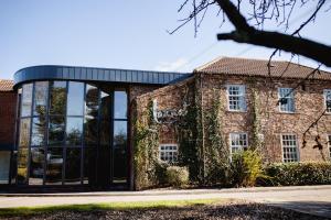 an old brick building with ivy growing on it at Lazaat Hotel in Hull