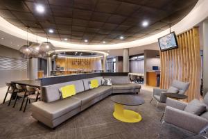 a lobby with a couch and a table and chairs at SpringHill Suites by Marriott Provo in Provo