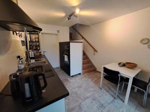 a kitchen with a black refrigerator and a white table at Ferienhaus 13b in Bad Orb
