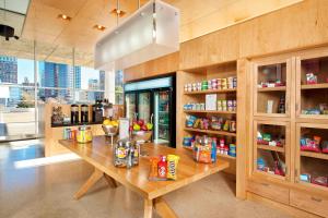 a room with a wooden table with food on it at Aloft Tulsa Downtown in Tulsa