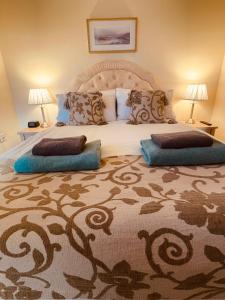 a bedroom with a large bed with two pillows on it at Talisker in Nairn