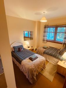 a hotel room with two beds and a window at Talisker in Nairn