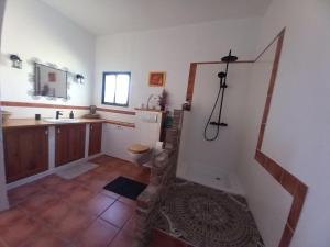 a bathroom with a sink and a toilet in a room at El Retiro - Casa Vibrante in Pilar de Jaravía