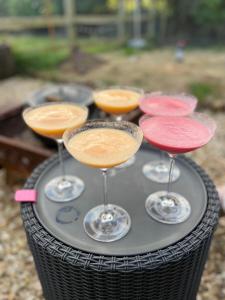 a group of four wine glasses on a table at A Unique & Tranquil Smallholding Retreat in Redruth