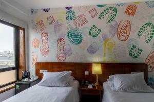 Postel nebo postele na pokoji v ubytování Hotel A.S. Sao Joao da Madeira