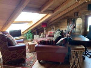 a living room with a couch and a piano at Private Luxury Spa & Silence Retreat with Spectacular View over the Lake Maggiore in Stresa