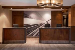 a lobby of a hotel with a painting on the wall at Residence Inn by Marriott Mont Tremblant Manoir Labelle in Mont-Tremblant