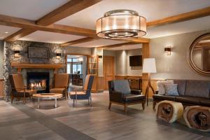 a living room with a couch and a fireplace at Residence Inn by Marriott Mont Tremblant Manoir Labelle in Mont-Tremblant