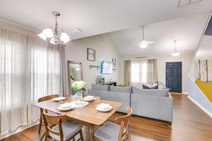 a dining room and living room with a table and chairs at Sleek Tallahassee Family Home - 5 Mi to Dtwn! in Tallahassee
