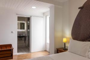 Postel nebo postele na pokoji v ubytování Hotel A.S. Sao Joao da Madeira