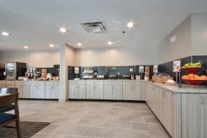 a large kitchen with a counter with fruits on it at Fairfield Inn & Suites Charlotte Arrowood in Charlotte