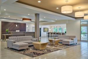 a lobby with two couches and a waiting room at Delta Hotels by Marriott Chicago Willowbrook in Willowbrook