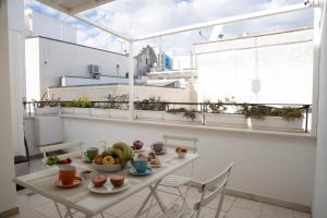 a room with a table with fruit on it at ENJOY BOUTIQUE ROOMS in Monopoli