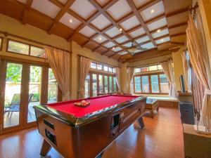 a room with a pool table in a house at Villano Lilawadee Pool Villa in Na Jomtien