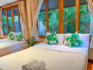 two beds in a room with a window at Villano Lilawadee Pool Villa in Na Jomtien +76 photos