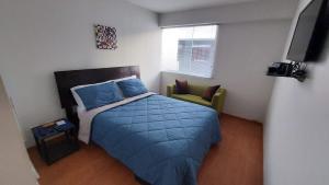 a small bedroom with a bed and a chair at Confortable and functional SUITE in MIRAFLORES ! in Lima