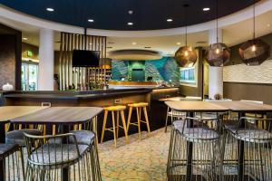 a bar with wooden tables and stools in a restaurant at SpringHill Suites Vero Beach in Vero Beach