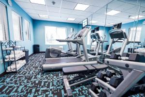 a gym with cardio equipment and blue walls at Fairfield by Marriott Medford Long Island in Medford