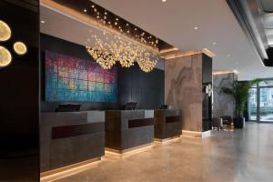 a lobby with a bar with a painting on the wall at Izmir Marriott Hotel in Izmir