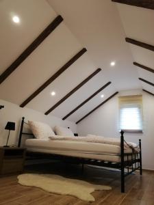 a bedroom with a large bed in a attic at Kuća za odmor Kustura in Ilok