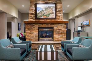 a waiting room with chairs and a fireplace at Residence Inn San Diego Oceanside in Oceanside