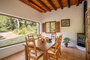 a dining room with a table and chairs and a window at Can Font in Santa Eularia des Riu