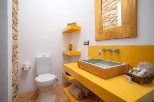 a bathroom with a sink and a toilet at Can Font in Santa Eularia des Riu +26 photos