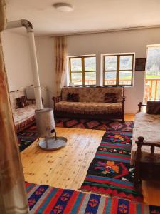 a living room with a couch and a rug at Sebishti Guesthouse 