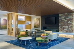 a lobby with a living room with a fireplace at Fairfield by Marriott Inn & Suites Hagerstown in Hagerstown