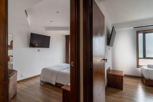 Postel nebo postele na pokoji v ubytování Hotel A.S. Sao Joao da Madeira