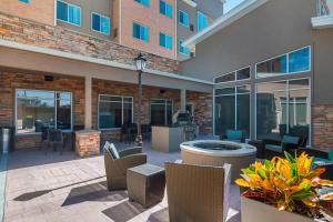 a patio with chairs and tables in front of a building at Residence Inn by Marriott Denton in Denton