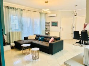 uma sala de estar com um sofá e duas mesas em eliTe deluxe residence em Kavala