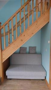 a wooden stairs with a bench under it at The Garden Apartment in Enniskillen
