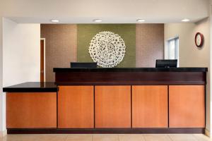 a lobby with a reception desk in a building at Fairfield Inn & Suites Stillwater in Stillwater