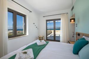 a bedroom with a bed with a view of the ocean at Christos Place-Paleochora in Palaiochora