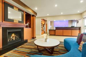 a living room with a fireplace and a tv at Fairfield Inn & Suites Omaha East/Council Bluffs, IA in Council Bluffs