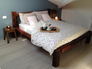 a bedroom with a bed with a tray of food on it at Ca' Irri Rent in Baveno