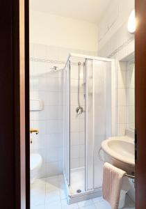 a bathroom with a shower and a toilet and a sink at Hotel Little in Rimini