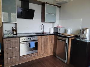 a small kitchen with a sink and a stove at Aparatment Zatoka Pucka in Puck