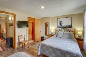 a bedroom with a bed and a flat screen tv at Snowed Inn Cozy Winterplace Ski-In and Ski-Out Cabin in Ghent