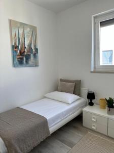 a bedroom with a bed and a painting on the wall at Volme Resort in Banjole +26 photos