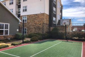 a tennis court in front of a building at Residence Inn Bryan College Station in College Station