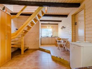 a kitchen and dining room with a staircase in a house at Domki na Chabrowej in Augustów