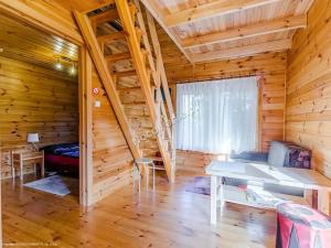 a log cabin with a bunk bed and a staircase at Domki na Chabrowej in Augustów