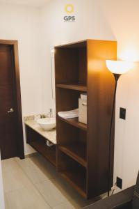 a bathroom with a cabinet with a sink and a lamp at Hotel boutique 402 in Mazatlán