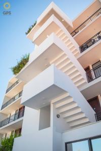 a white building with a spiral staircase at Hotel boutique 402 in Mazatlán