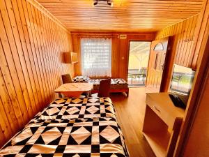 a room with a bed and a table in a room at Pokoje Nad Klifem in Trzęsacz +10 photos