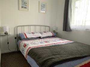 a bed with two pillows on it in a bedroom at bulldog holidays 244 in Hemsby