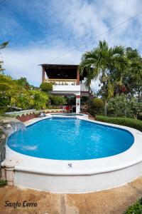 a swimming pool in front of a house at Hotel Santo Cerro Natural Park in Santo Cerro